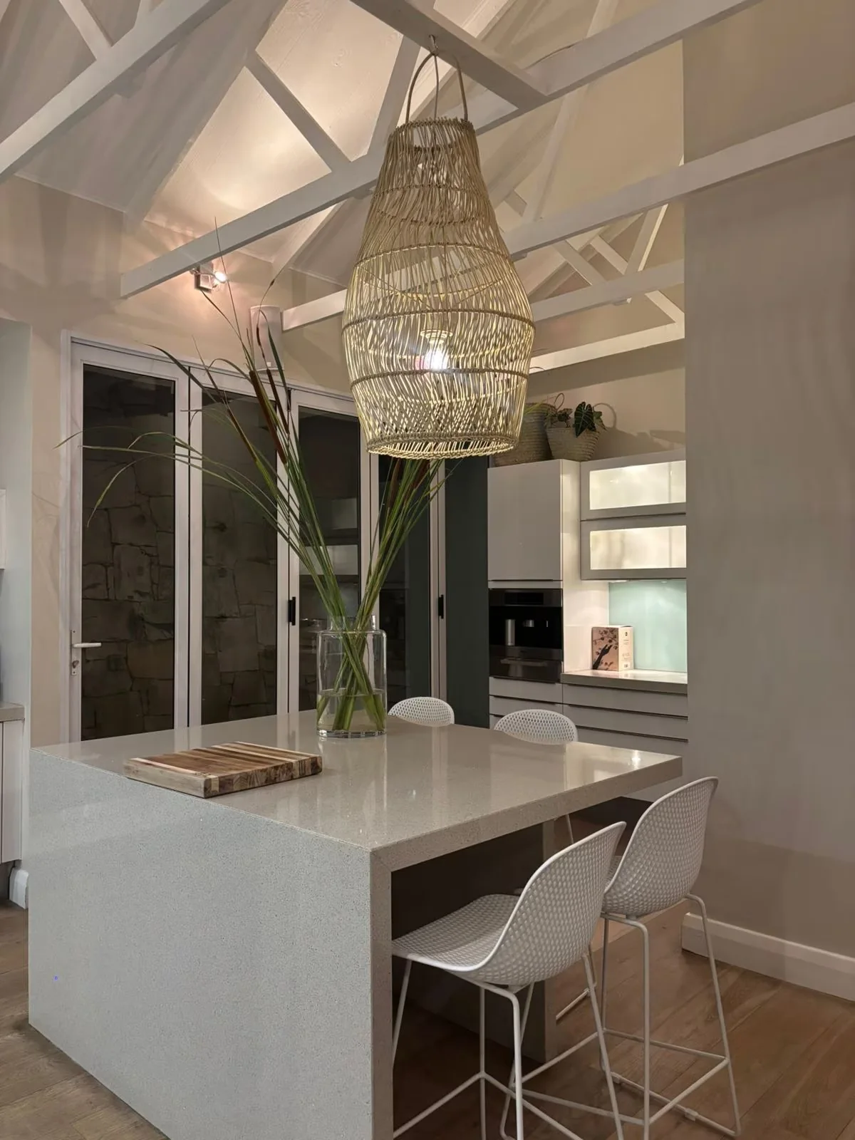 Dining table beneath a sculptural pendant light