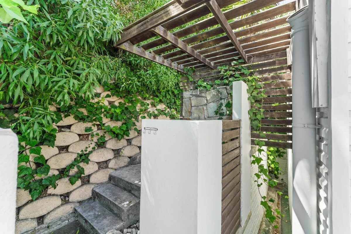 Outdoor shower in a leafy courtyard